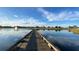 Picturesque golf course with a wooden bridge over water under a brilliant blue sky at 1506 Euston Dr, Reunion, FL 34747