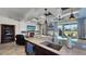 Open-concept kitchen and living area with modern countertops, custom ceiling, and view to covered patio at 1506 Euston Dr, Reunion, FL 34747
