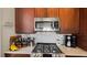 Close up of modern stainless steel oven, stovetop and tile backsplash in a gourmet kitchen at 1506 Euston Dr, Reunion, FL 34747