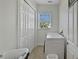 Clean laundry room featuring white appliances, tiled floor, and bright light at 1506 Euston Dr, Reunion, FL 34747