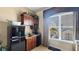 A bright nook featuring a retro refrigerator, microwave, sink, and exterior views at 1506 Euston Dr, Reunion, FL 34747