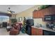 Cozy living room featuring a retro mini-kitchen, comfortable leather seating, and bright natural light at 1506 Euston Dr, Reunion, FL 34747