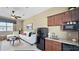 Cozy living room with a wet bar area including a mini fridge, sink, and cabinets for storage at 1506 Euston Dr, Reunion, FL 34747