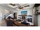 Inviting living room featuring a cozy fireplace, custom ceiling, and hardwood floors, with a staircase nearby at 1506 Euston Dr, Reunion, FL 34747