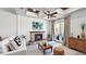 Bright living room with fireplace, neutral walls, wood floors and access to outdoor living at 1506 Euston Dr, Reunion, FL 34747