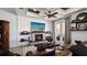 Inviting living room featuring a cozy fireplace, custom ceiling, and hardwood floors with natural lighting at 1506 Euston Dr, Reunion, FL 34747