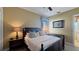Comfortable main bedroom with side tables and lamps and a nice view from the window at 1506 Euston Dr, Reunion, FL 34747