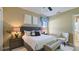 Serene bedroom features neutral tones, a plush bed, and comfortable seating for relaxation at 1506 Euston Dr, Reunion, FL 34747