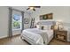 Bright bedroom with large windows, decorative ladder, and wood floors, filled with natural light at 1506 Euston Dr, Reunion, FL 34747