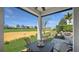 Covered patio with a table and chairs, offering a relaxing outdoor space overlooking the golf course and community at 1506 Euston Dr, Reunion, FL 34747