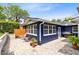 A private backyard with a blue house, brick pavers, a grill, a small table, and some chairs at 1510 E Ridgewood St, Orlando, FL 32803