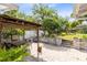 Backyard patio featuring a dining area with a pergola, brick pavers, and a lush garden at 1510 E Ridgewood St, Orlando, FL 32803