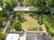 Aerial view of a lush backyard with a patio, manicured landscaping, and a garden at 1510 E Ridgewood St, Orlando, FL 32803