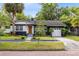 Inviting blue home boasts a well-kept lawn, shade trees, and a brick-paved street at 1510 E Ridgewood St, Orlando, FL 32803