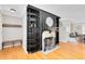 Cozy living room featuring a fireplace with built-in shelving and hardwood floors at 1510 E Ridgewood St, Orlando, FL 32803
