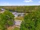 Beautiful aerial view of home on waterfront surrounded by lush green trees and manicured lawn at 1532 Reade Cir, St Cloud, FL 34772