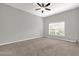 Bedroom with carpet floors, ceiling fan, and large window at 1532 Reade Cir, St Cloud, FL 34772