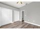 Spacious bedroom with hardwood floors, ceiling fan, and ample closet space at 1532 Reade Cir, St Cloud, FL 34772
