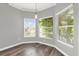 Bright dining area featuring hardwood floors and large windows with natural light at 1532 Reade Cir, St Cloud, FL 34772