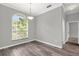 Bright dining area featuring hardwood floors and a large window with natural light at 1532 Reade Cir, St Cloud, FL 34772