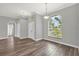 Bright living room with wood floors, modern paint, arched windows, and views of the outdoors at 1532 Reade Cir, St Cloud, FL 34772