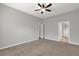 Main bedroom featuring carpet floors and an ensuite bathroom with a walk-in shower at 1532 Reade Cir, St Cloud, FL 34772