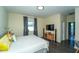 Bright bedroom with gray accents, natural light, and a TV entertainment center at 1599 Thetford Cir, Orlando, FL 32824