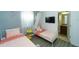 ' bedroom featuring two twin beds, a modern light fixture, and an ensuite bathroom at 1599 Thetford Cir, Orlando, FL 32824