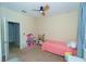 Cozy bedroom with a ceiling fan, furnishings, and neutral color scheme at 1599 Thetford Cir, Orlando, FL 32824