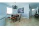 Modern dining space with open floor plan, gray walls, statement lighting, and long table with seating at 1599 Thetford Cir, Orlando, FL 32824