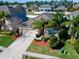 Aerial view of a single-Gathering home with palm trees and well-kept landscaping at 1599 Thetford Cir, Orlando, FL 32824