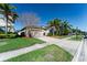 Exterior shot showing the house, driveway, lawn, and curb appeal at 1599 Thetford Cir, Orlando, FL 32824