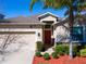 Charming single-story home featuring a well-manicured front yard and attached two-car garage at 1599 Thetford Cir, Orlando, FL 32824