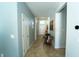Long hallway with front door, tile floors, light gray paint, and decor at 1599 Thetford Cir, Orlando, FL 32824