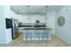 Modern kitchen with island seating, stainless appliances, and geometric pendant lighting at 1599 Thetford Cir, Orlando, FL 32824