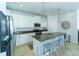 Stylish kitchen featuring an island with seating, stainless steel appliances, and modern lighting at 1599 Thetford Cir, Orlando, FL 32824