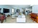 Open-concept living area with modern furnishings and a view of the kitchen and dining space at 1599 Thetford Cir, Orlando, FL 32824