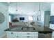 Open floorplan showing the kitchen island and view into the living and dining areas at 1599 Thetford Cir, Orlando, FL 32824