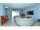 Spacious living room featuring comfortable sofa, grand piano, and sliding glass doors at 1599 Thetford Cir, Orlando, FL 32824