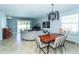 Spacious living space with dining area, piano, large sectional, and modern lighting at 1599 Thetford Cir, Orlando, FL 32824