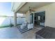 Covered patio area with sliding glass door and outdoor seating at 1599 Thetford Cir, Orlando, FL 32824