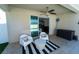 View from covered patio into home showing sliding glass door and outdoor seating area at 1599 Thetford Cir, Orlando, FL 32824
