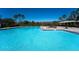 Outdoor pool area with inviting clear water and surrounding lounge chairs at 1599 Thetford Cir, Orlando, FL 32824
