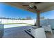 Covered patio featuring a ceiling fan, outdoor seating, and a fenced pool at 1599 Thetford Cir, Orlando, FL 32824