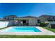 Rear exterior view of the home showcasing the swimming pool and patio at 1599 Thetford Cir, Orlando, FL 32824
