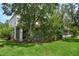 Secluded backyard with lush green lawn and mature landscaping, ideal for outdoor enjoyment at 1607 Tail Feather Dr, Kissimmee, FL 34746