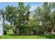 Lush backyard with mature trees and shrubs, providing privacy and a natural setting at 1607 Tail Feather Dr, Kissimmee, FL 34746