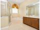 Bathroom featuring tiled walk-in shower, soaking tub and vanity with dual sinks at 1607 Tail Feather Dr, Kissimmee, FL 34746