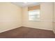 Bedroom with carpet flooring and a window with blinds at 1607 Tail Feather Dr, Kissimmee, FL 34746