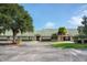 Oaks National Golf Club building featuring classic architecture and lush greenery at 1607 Tail Feather Dr, Kissimmee, FL 34746